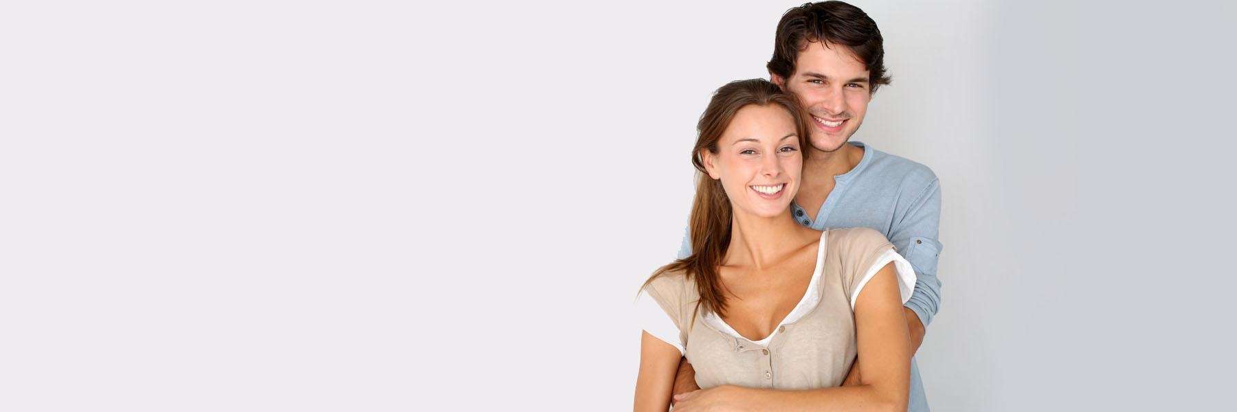 A smiling couple against a white background