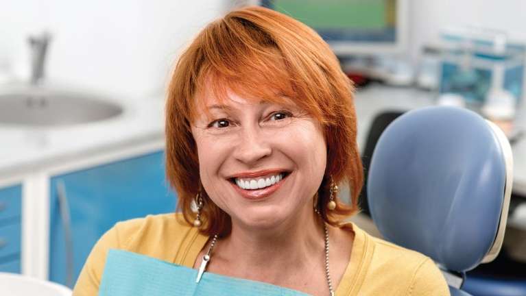 A smiling woman at the dentist's office