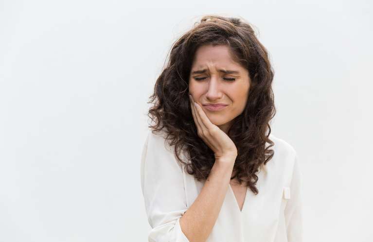 Woman experiencing severe tooth pain in Winchester KY