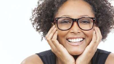 A woman with glasses smiling | dental restorations Winchester KY
