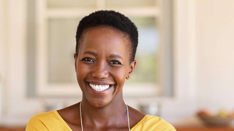 A woman smiling in her home | dental health winchester ky