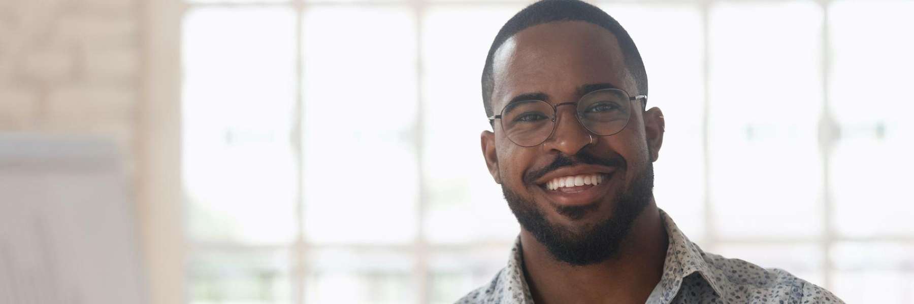 Man wearing eyeglasses smiling after receiving root canal in Winchester KY